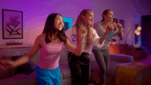 Friends dancing in a colorful room.