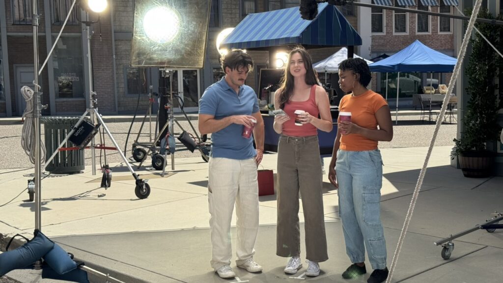 Actor using the NYRA Bets mobile wagering app on a smartphone during a broadcast commercial shot by Evolution