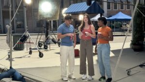 Actor using the NYRA Bets mobile wagering app on a smartphone during a broadcast commercial shot by Evolution