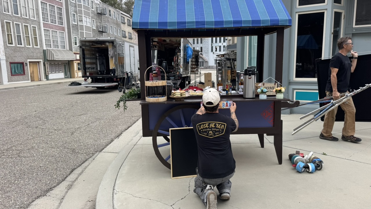 Agile commercial production transforming an empty backlot into a bustling urban farmers market with a custom coffee cart